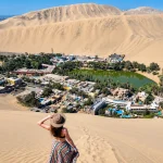 Vista panorámica del oasis de Huacachina rodeado por dunas de Ica